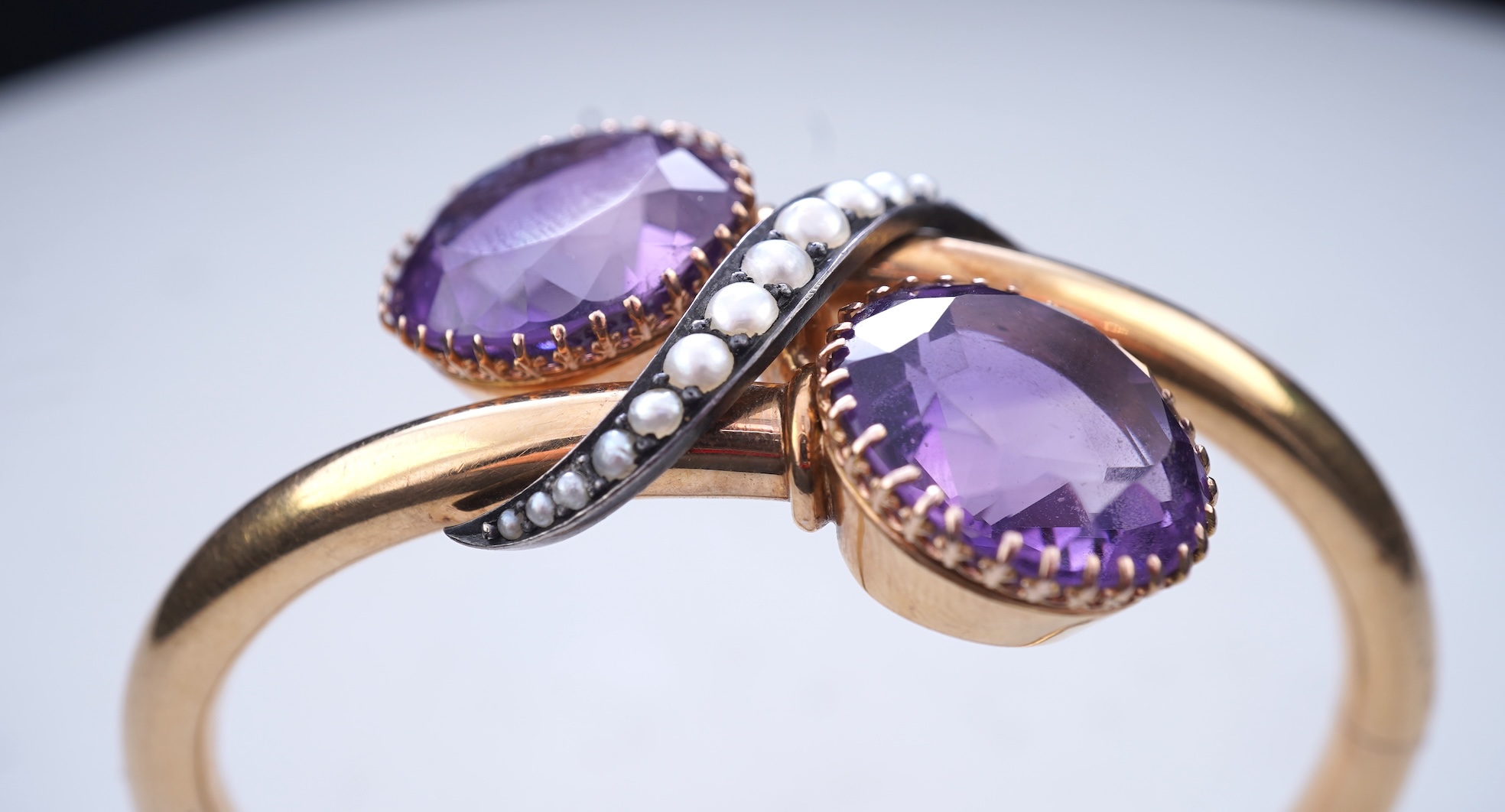 A Victorian gold, pearl and amethyst bangle, late 19th century